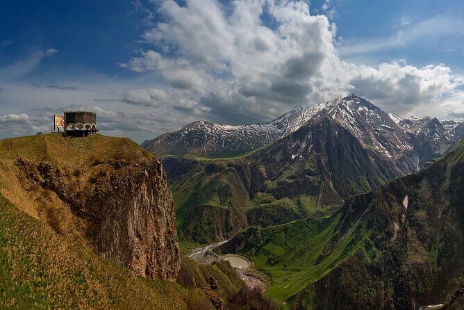 From Tbilisi: Kazbegi Day Tour, Gergeti Trinity, Ananuri &Gudauri - Russian–Georgian Friendship Monument: Cold War-era murals and big mountain angles